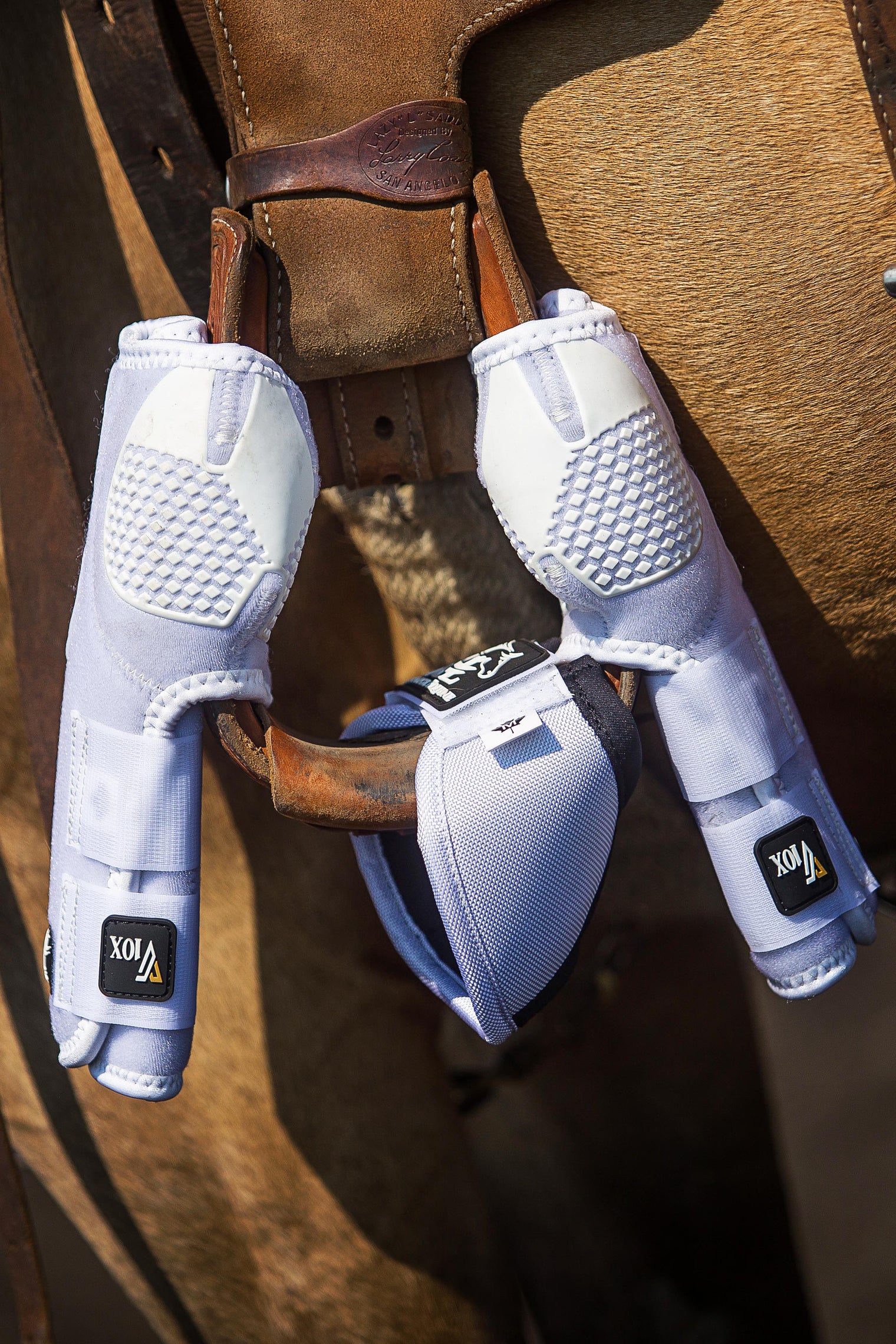 White V20x Sport Protective Boots and NO Turn Bell Boots on saddle stirrup.
